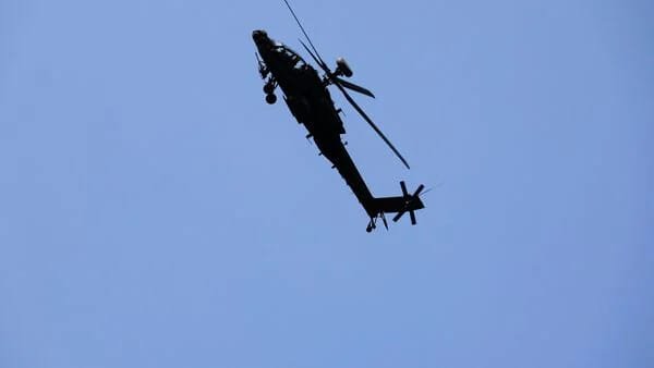 Scandal in the air: 2 soldiers caught in an ill-suited position in UK Apache cockpit.